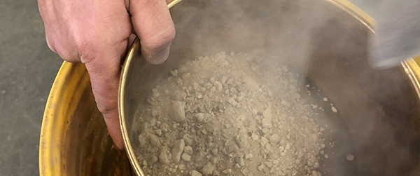 Mt. Mazama ash being poured into a yellow bucket