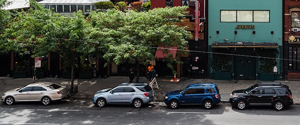 Cars parked along the curb of a street