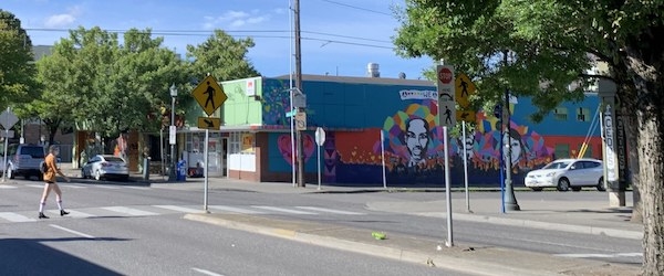 View of North MLK Boulevard in Portland, Oregon with a pedestrian crossing near a mural.