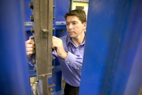 Portland State University associate professor Peter Dusicka inspects a bolted connection between two steel girders at the infraStructure Testing and Applied Research Laboratory. Dusicka's research is helping Oregon's transportation network withstand major earthquakes with as little disruption as possible.