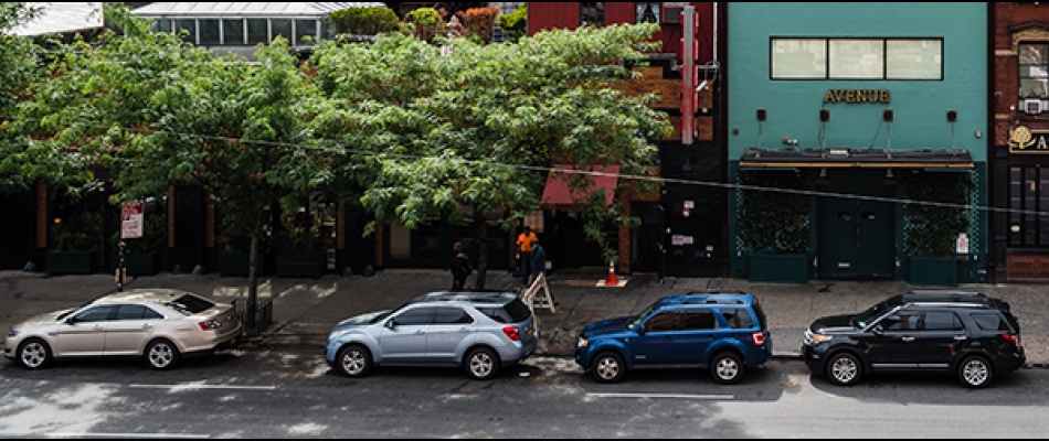 Cars parked along the curb of a street